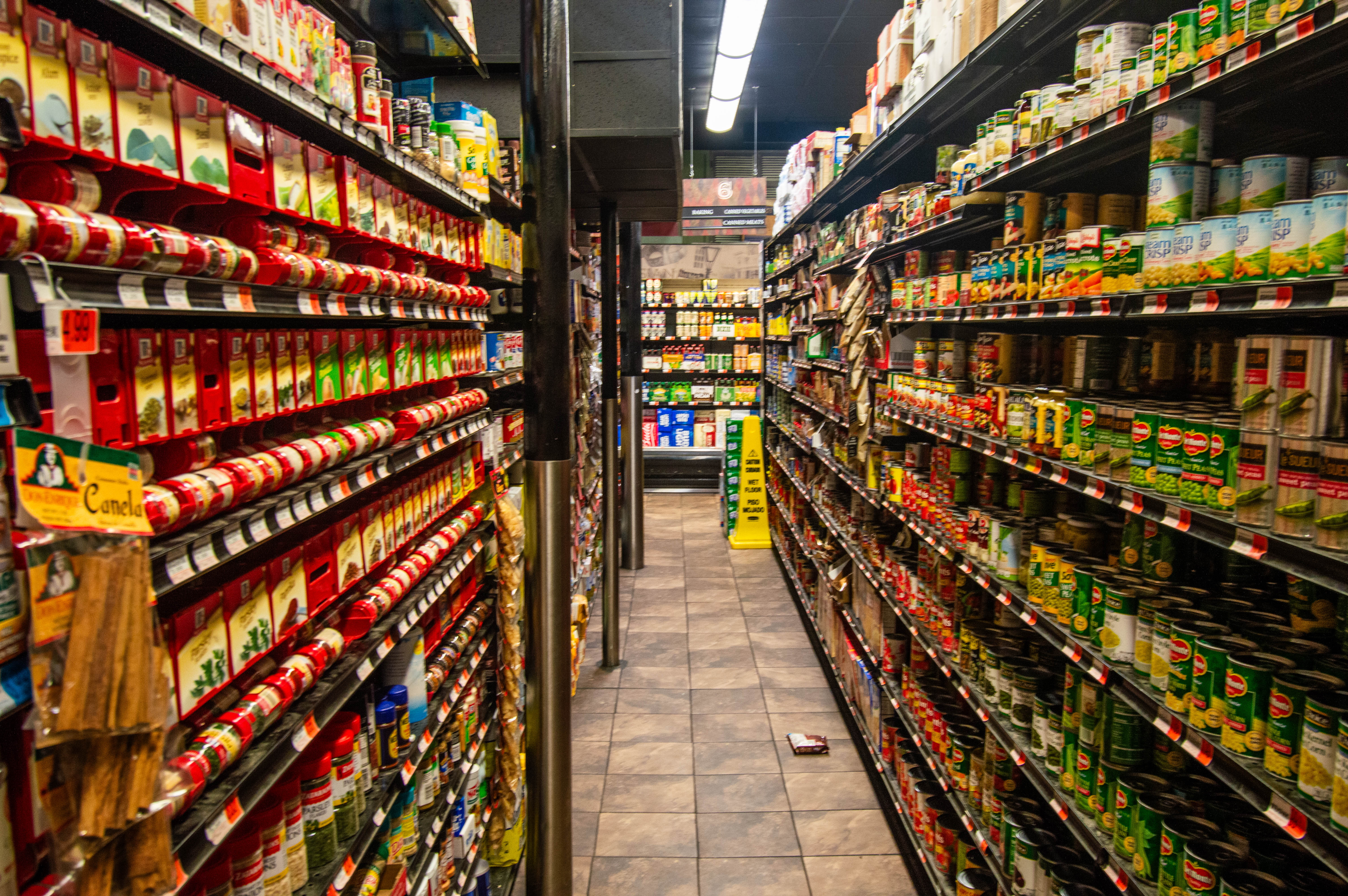 Empty supermarket aisle with stocked shelves